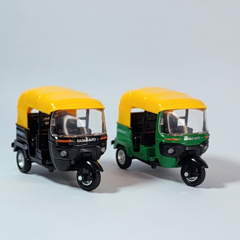 Set of two die-cast models of Indian Auto Rickshaws (Tuk-Tuks) in green and black with yellow canopies, against a white background. Khilone for kids