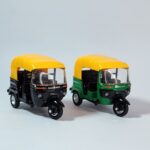Set of two die-cast models of Indian Auto Rickshaws (Tuk-Tuks) in green and black with yellow canopies, against a white background. Khilone for kids