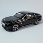 Sleek black 1:24 scale Rolls-Royce Phantom die-cast model car with gold pinstriping, showing detailed wheels and a luxurious design. Khilone for kids