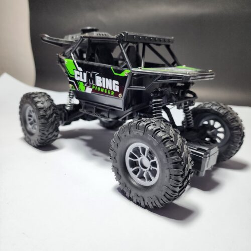 Black and green "Climbing Pioneer" RC rock crawler with large rubber tires and high suspension Khilone for kids