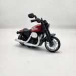 Red and black "Storm Chaser" cruiser motorcycle die-cast model with chrome-look exhaust pipes and detailed wheels on a white background. khilone for kids